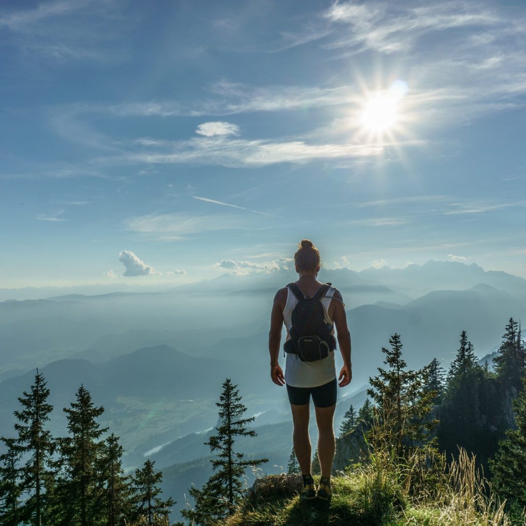 A hiker enjoy sunlight standing on a hill whatsapp dp image