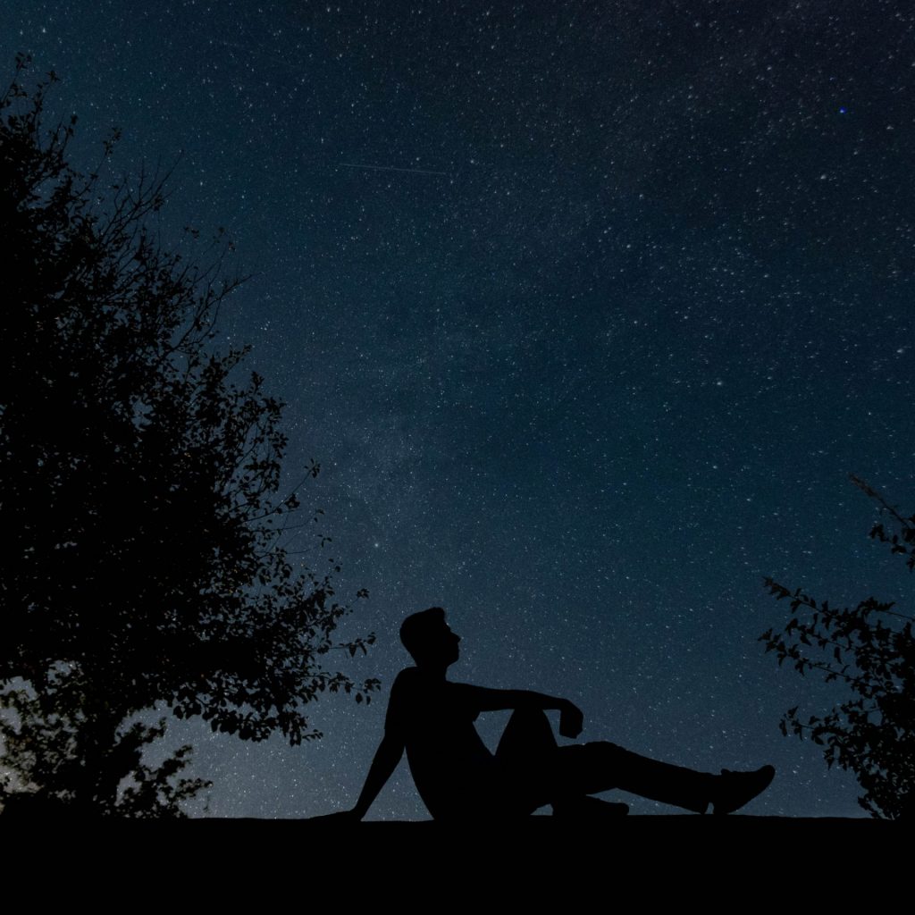A Man Enjoy Stars Night Seating On A Rock Whatsapp Dp Image