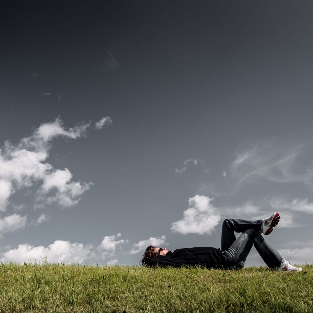 A Man Sleeping In The Grass Field Whatsapp Dp Image