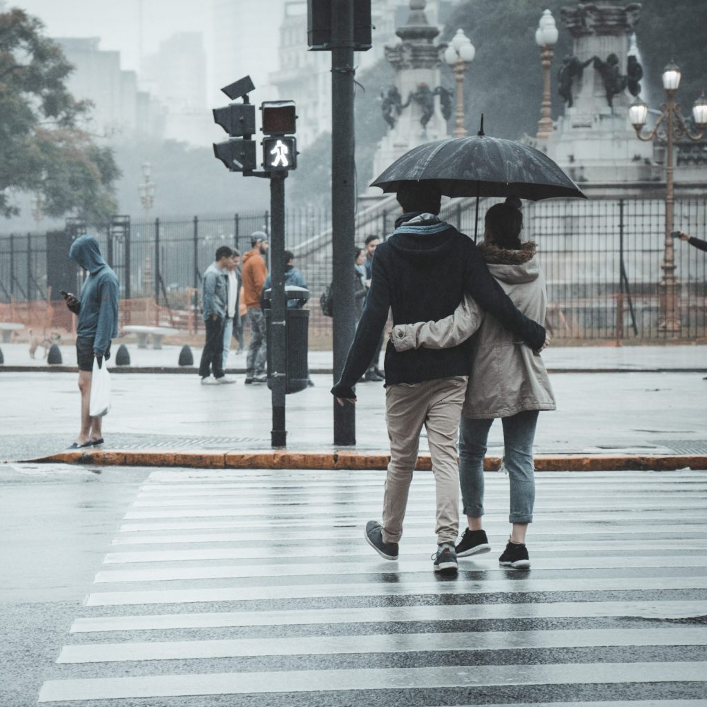 A couple walking in the rain whatsapp dp image