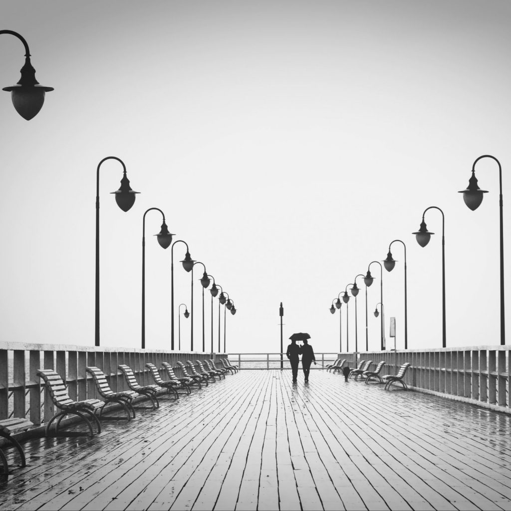 A couple walking in the rain with umbrella whatsapp dp image