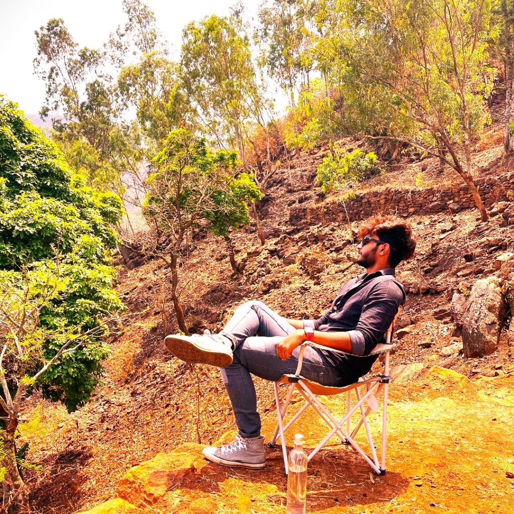 Harsha Sai Enjoying Sunlight Seating On A Chair WhatsApp DP Image