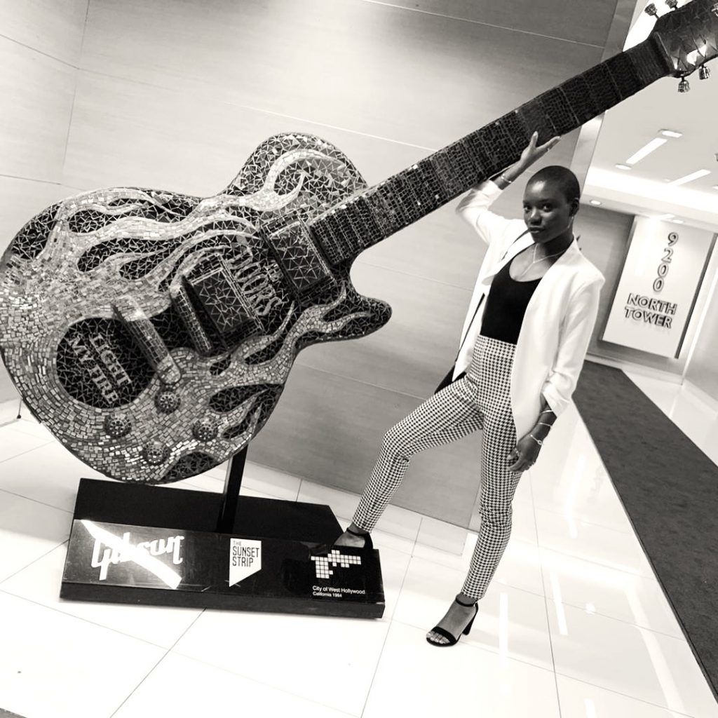 Alexis Louder Holding A Big Guitar WhatsApp DP Image